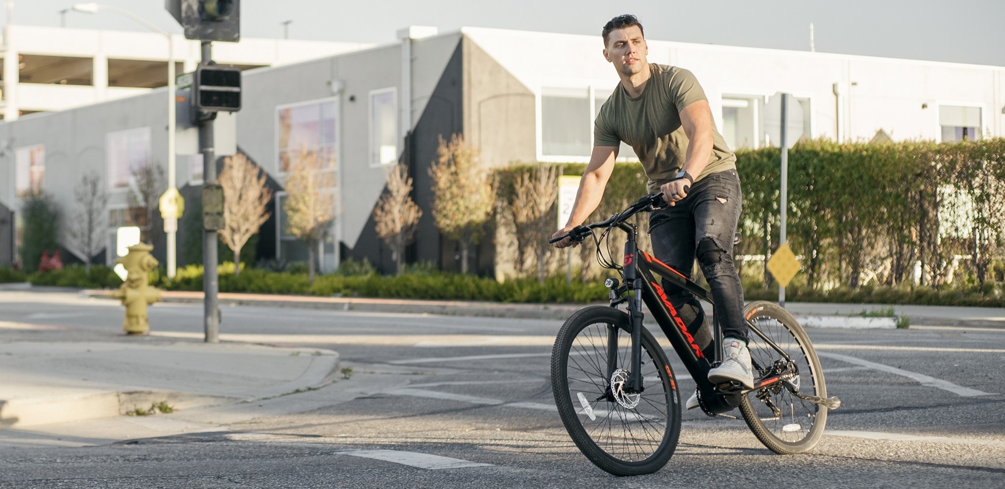 Man riding Avadar C3-Sport Mid-drive Electric Mountain Bike in the City